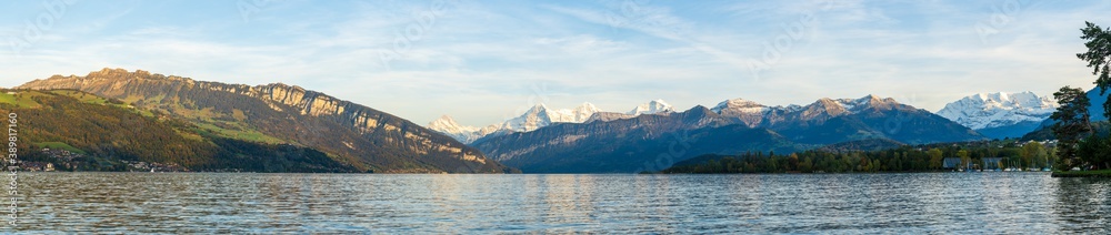 view of the lake with swiss alps mountains in background in autumn