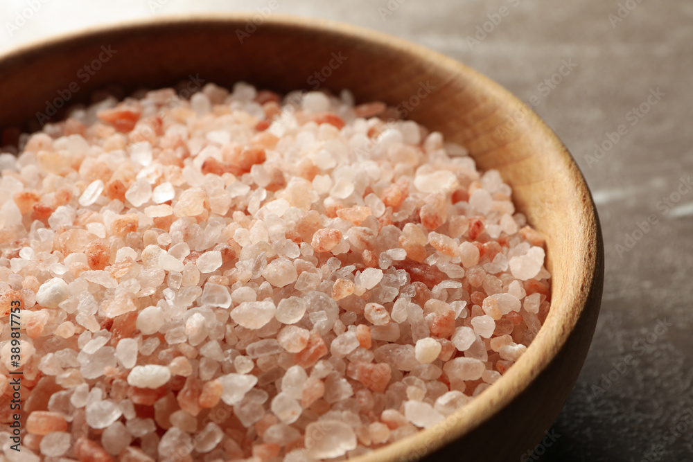 Bowl of pink himalayan salt on gray background Bowl of pink himalayan salt on gray background