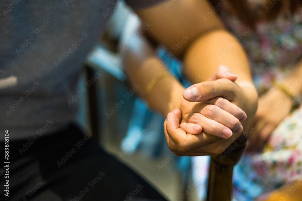 Φωτογραφία Closeup on two young lovers holding hands at a table, symbol sign sincere feelings, compassion, loved one, say sorry