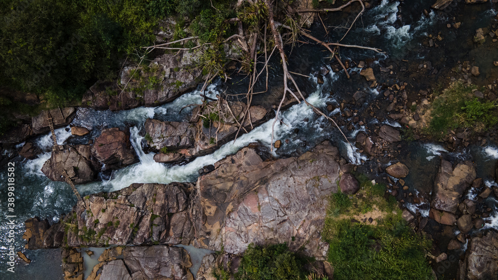 Fototapeta premium Beautiful river flows down through the rocks in the forest 