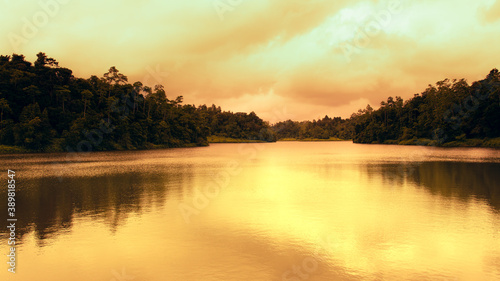 Golden sunset colors in Hiyare reservoir landscape photograph.