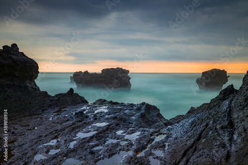 Picturesque seascape. Amazing landscape. Rock in the ocean. Motion waves. Silky water. Long exposure image. Soft focus. Concept of nature background. Mengening beach, Bali