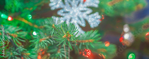 Bright christmas tree with decorations and colorful lights, soft focus blurry background