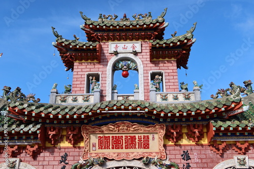 Hoi An, Vietnam, October 29, 2020: Detail of the colorful main door of the Assembly Hall Of Fujian Chinese Temple in Hoi An