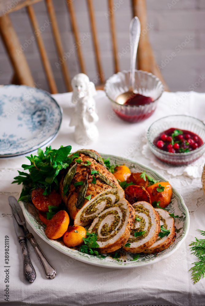 Turkey porchetta with caramelised clementines on the Christmas background .style rustic.