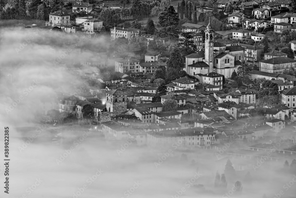 Italian city wrapped by fog at morning 