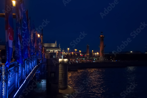 Illuminated bridge over the river at night. Blurry background photo. View of Saint Petersburg.