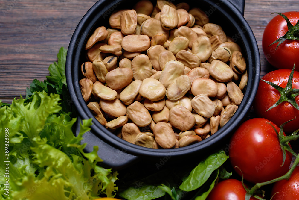various vegetables background. vicia faba beans, tomatoes. Health vegan and vegetarian food concept. Foods high in antioxidants, fiber, smart carbohydrates and vitamins. Top view various vegetables background. vicia faba beans, tomatoes. Health vegan and vegetarian food concept. Foods high in antioxidants, fiber, smart carbohydrates and vitamins. Top view