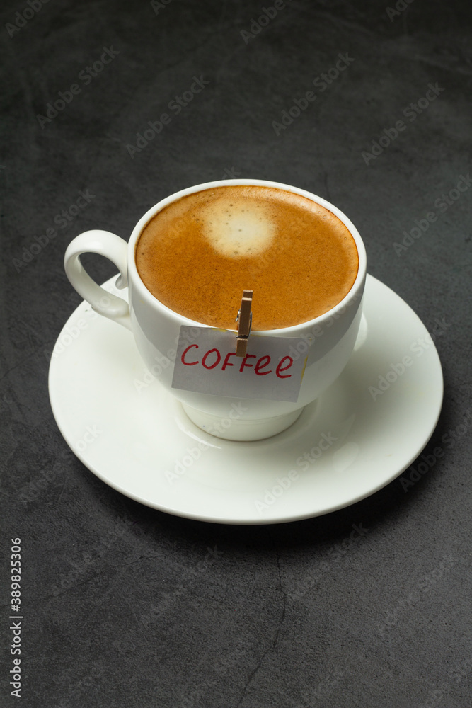 black coffee in and a leaf with the inscription coffee. black coffee in and a leaf with the inscription coffee.