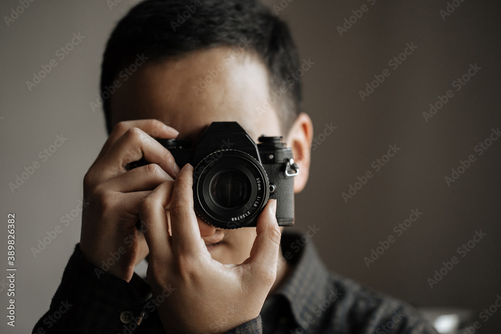 Man taking a picture on a pentax film camera Man taking a picture on a pentax film camera