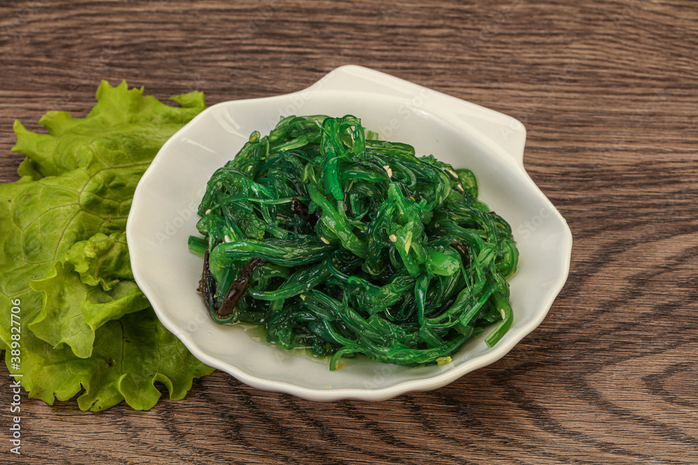 Green Chuka Seaweed Salad Isolated on White Background Top View. Wakame Sea Kelp Salat Green Chuka Seaweed Salad Isolated on White Background Top View. Wakame Sea Kelp Salat