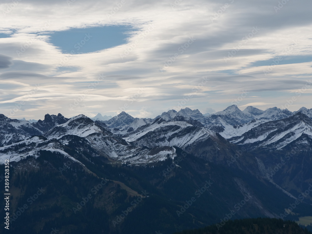 Panorama-Blick über die schneebedeckten Alpen in Tirol in Österreich bei guter Fernsicht und leicht bewölktem Himmel