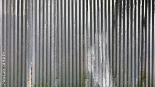 Old galvanized fence. Metal background and wavy metal texture full frame For background work Selective focus