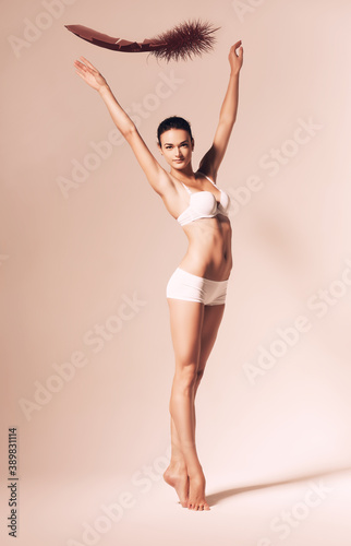 ballet dancer in white clothing with feather