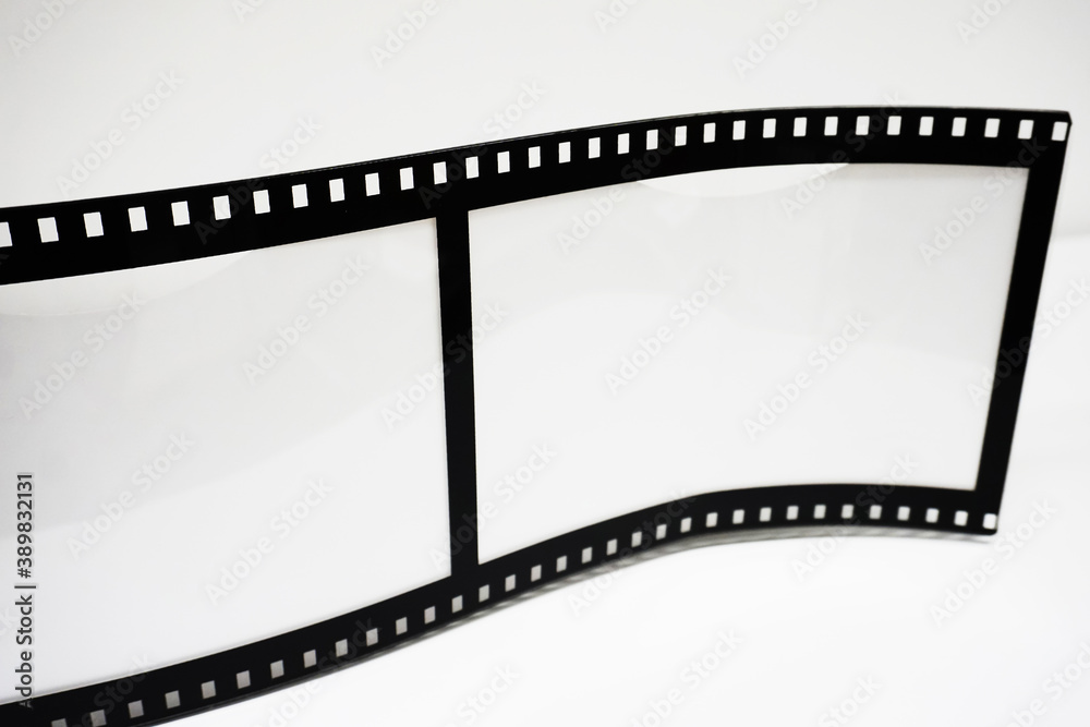 Perforation of a black and white negative film on a white background.