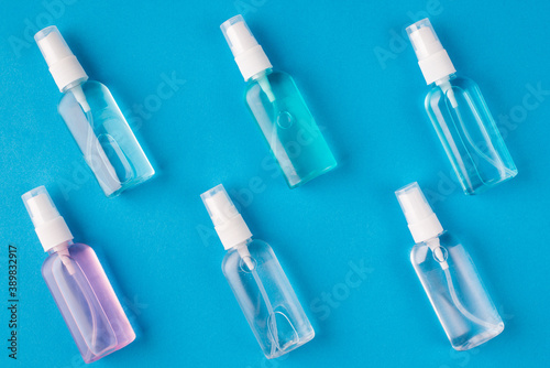 Close up above top overhead close up photo picture of different extract sanitizers isolated over bright color blue background
