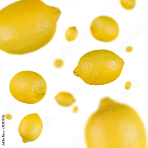 Many lemons free falling on white background. Selective focus - shallow depth of field.