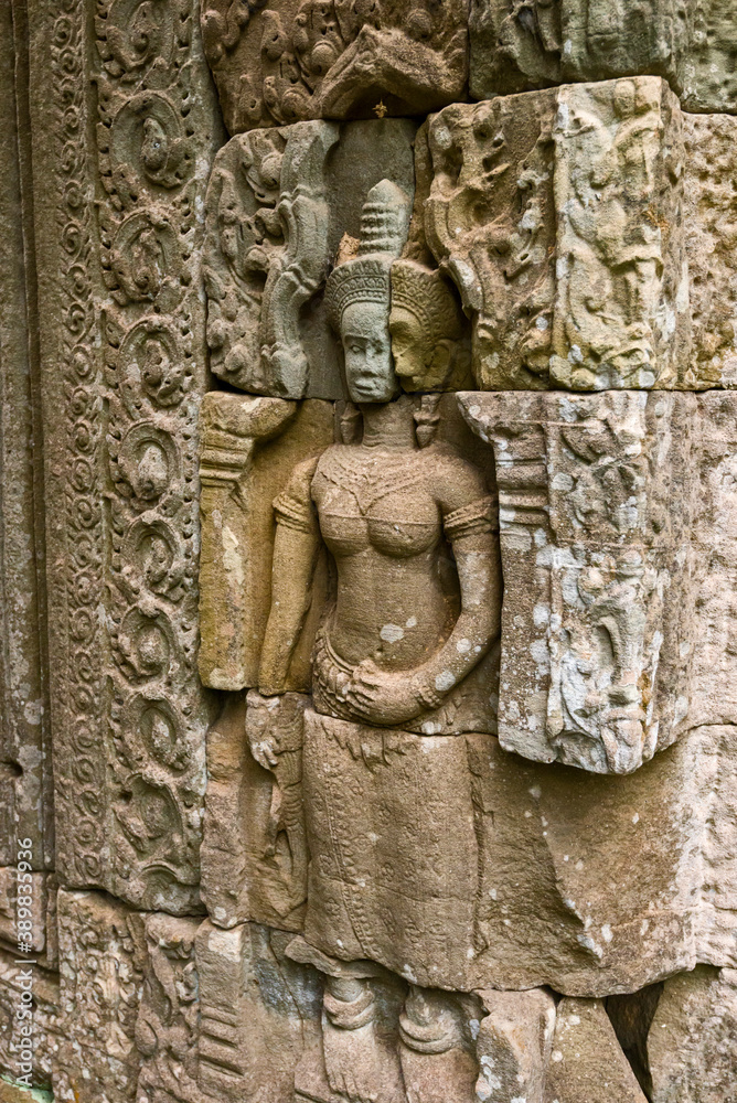 statue of a Devata deities with an enigmatic smile in Preah Khan temple, in Angkor Thom in Siem Reap Cambodia