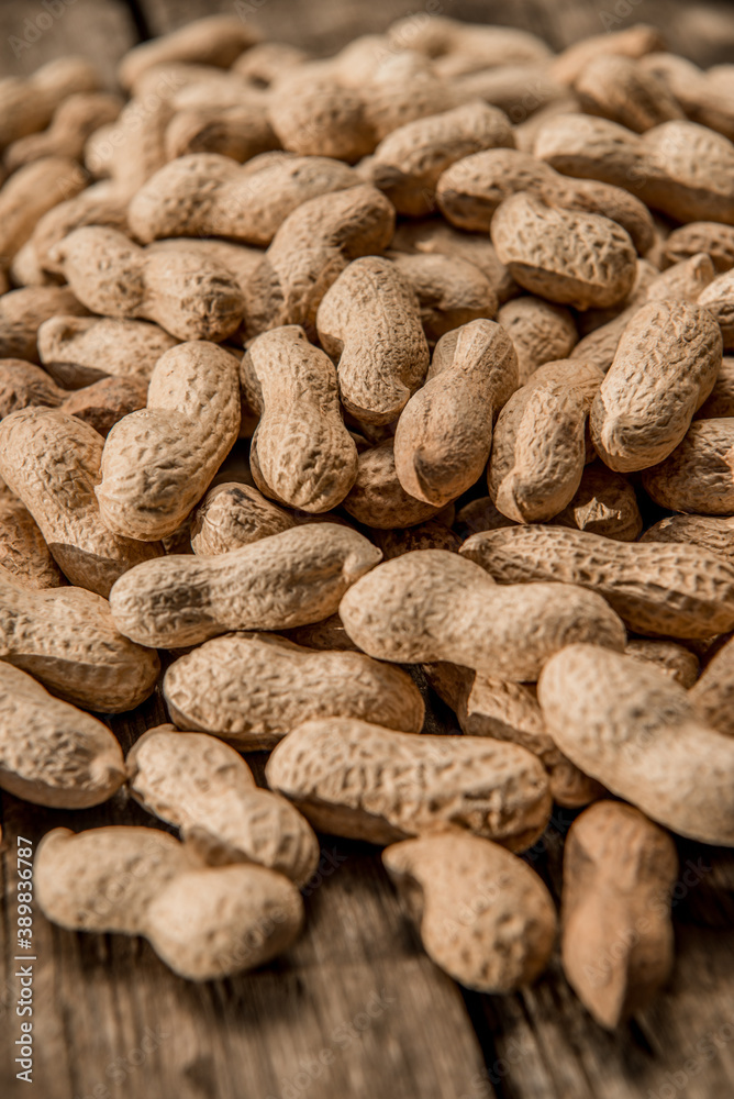 Dried peanuts closeup photo. Peanut in the shell. Food background of peanuts, healthy vegan food Dried peanuts closeup photo. Peanut in the shell. Food background of peanuts, healthy vegan food