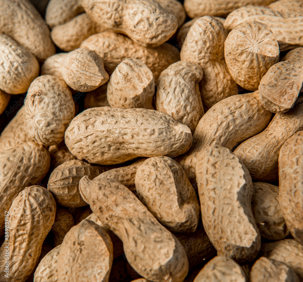 Dried peanuts closeup photo. Peanut in the shell. Food background of peanuts, healthy vegan food Dried peanuts closeup photo. Peanut in the shell. Food background of peanuts, healthy vegan food