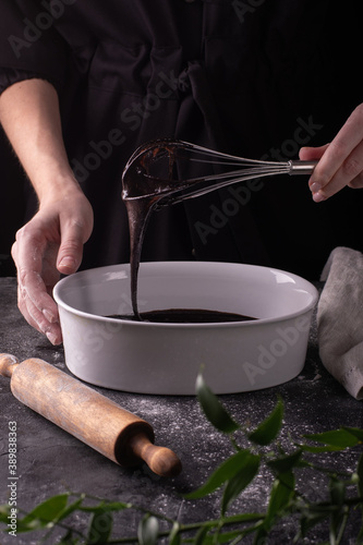 Woman preparing the dough for a birthday cake with chocolate