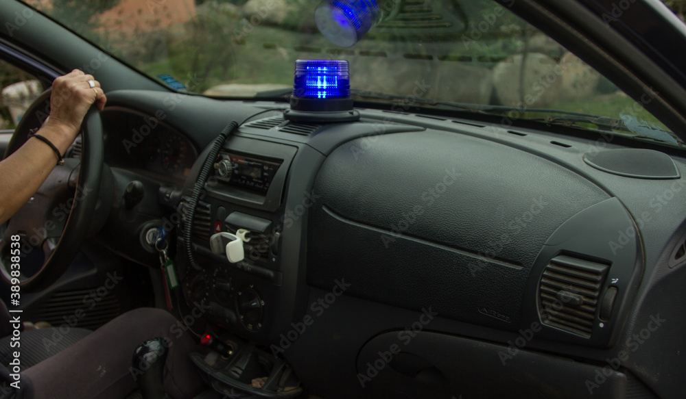 close-up of a blue police flashing light on inside the car