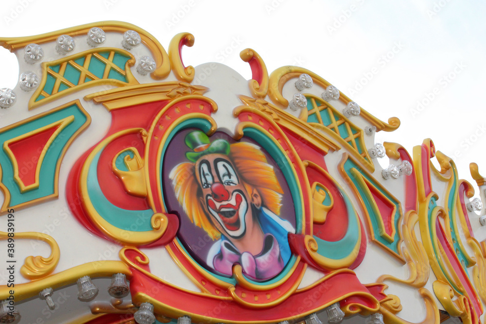Fragment of the carousel at the fair, the clown