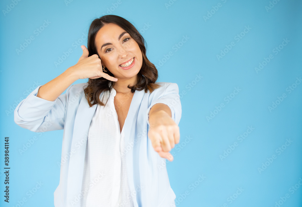 Portrait of attractive happy woman gesturing with fingers call me over blue background. Portrait of attractive happy woman gesturing with fingers call me over blue background.