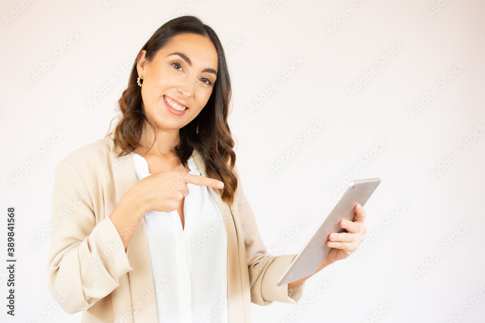 Smiling businesswoman holding tablet in hands. Isolated on white.