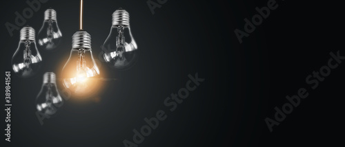 Abstract hand holding creative light lightbulb on isolated black background Present futuristic digital technology knowledge education Concept of transformation innovation invention discovery
