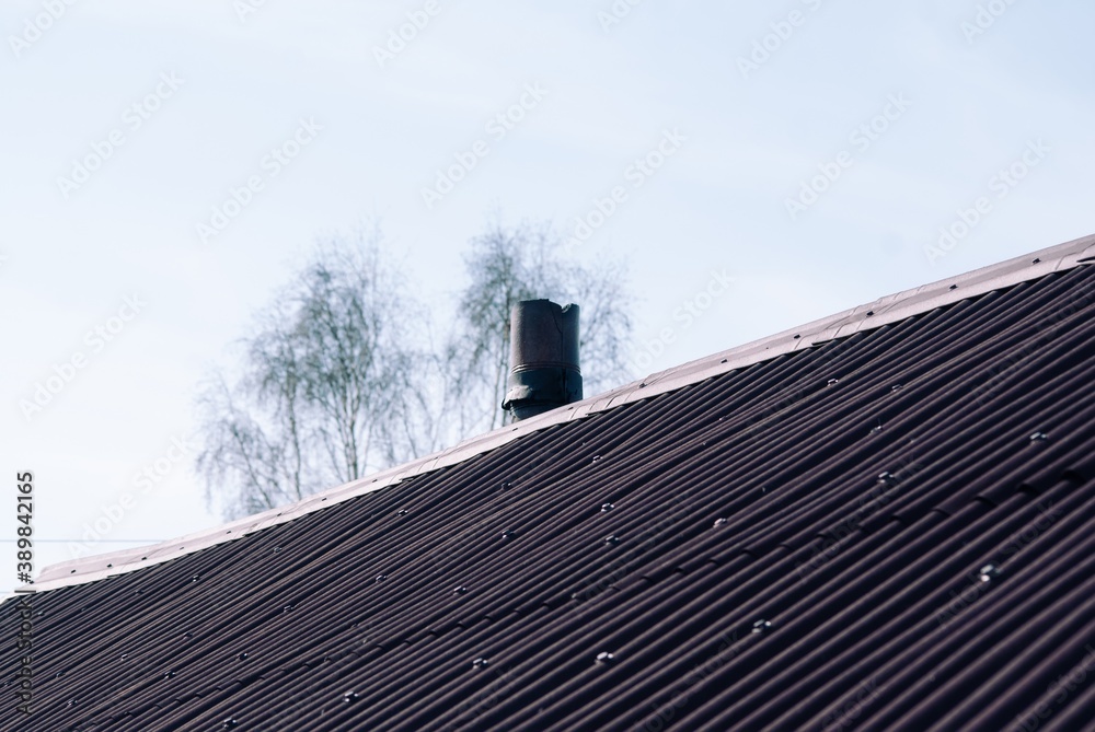 plastic shingles on the roof of a rural house