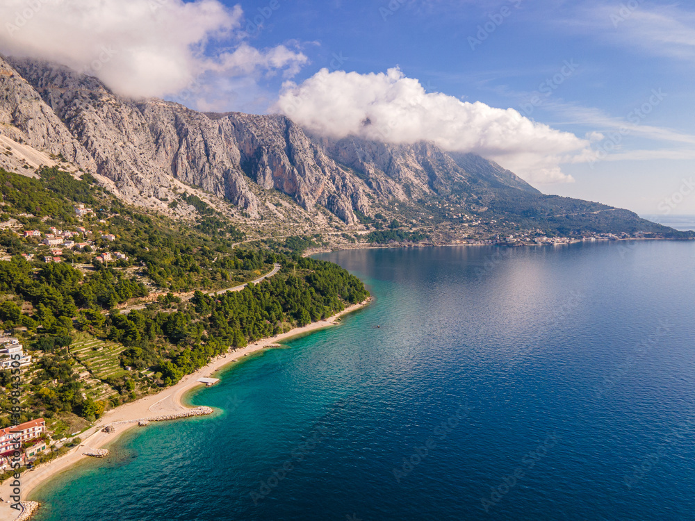Obraz premium Amazing view at Makarska rivera beaches with apartments in Makarska Riviera. Podgora-Caklje area with high mountain Biokovo in background. Drone view. Croatia, Dalmatia