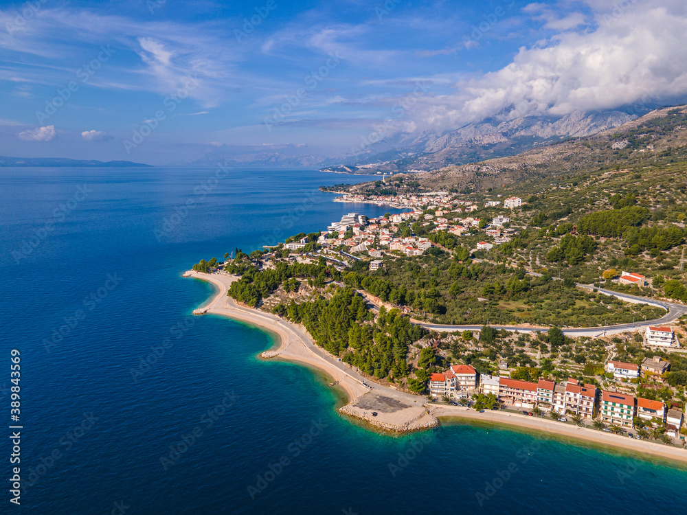Amazing view at Makarska rivera beaches with apartments in Makarska Riviera. Podgora-Caklje area with high mountain Biokovo in background. Drone view. Croatia, Dalmatia