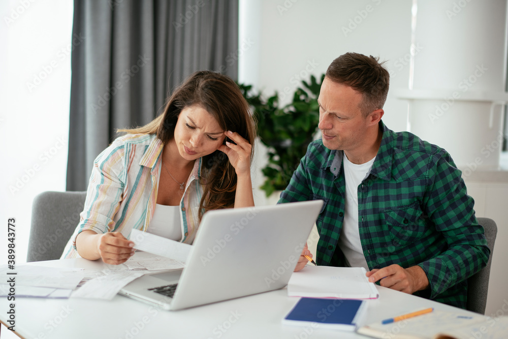Husband and wife preparing bills to pay. Young couple using laptop. Husband and wife preparing bills to pay. Young couple using laptop.