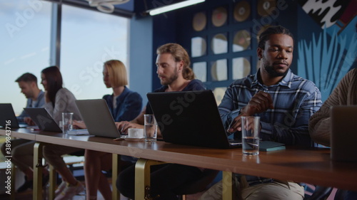 Multiethnic business people working laptop computers at workplace in coworking