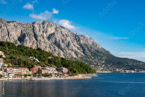 Amazing view at Makarska rivera beaches with apartments in Makarska Riviera. Podgora-Caklje area with high mountain Biokovo in background. Croatia, Dalmatia