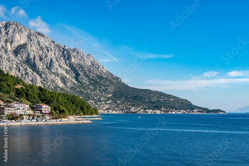 Amazing view at Makarska rivera beaches with apartments in Makarska Riviera. Podgora-Caklje area with high mountain Biokovo in background. Croatia, Dalmatia