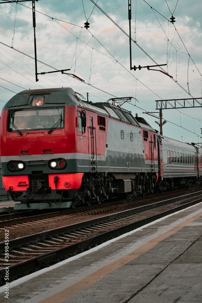 Locomotive with passenger wagons, railway, rails, tracks, train red