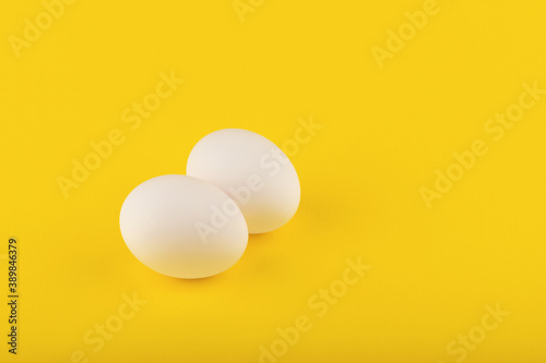 chicken eggs on yellow background