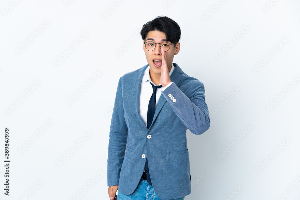 Young Chinese business man isolated on white background shouting with mouth wide open Young Chinese business man isolated on white background shouting with mouth wide open
