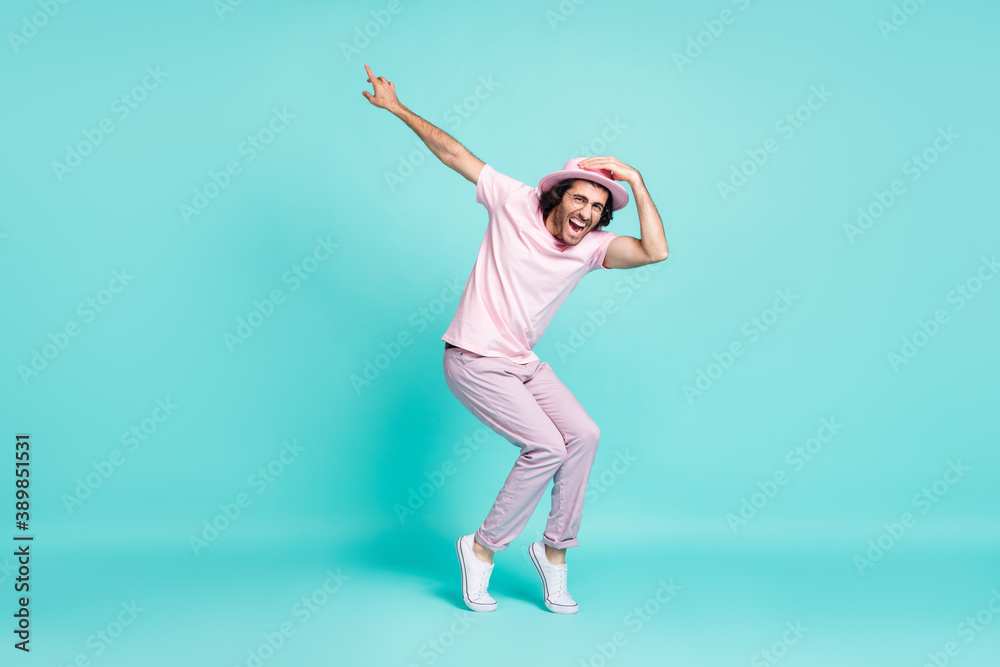 Full size profile photo of optimistic cool guy dancing wear spectacles pastel pink cap t-shirt pants sneakers isolated on teal background