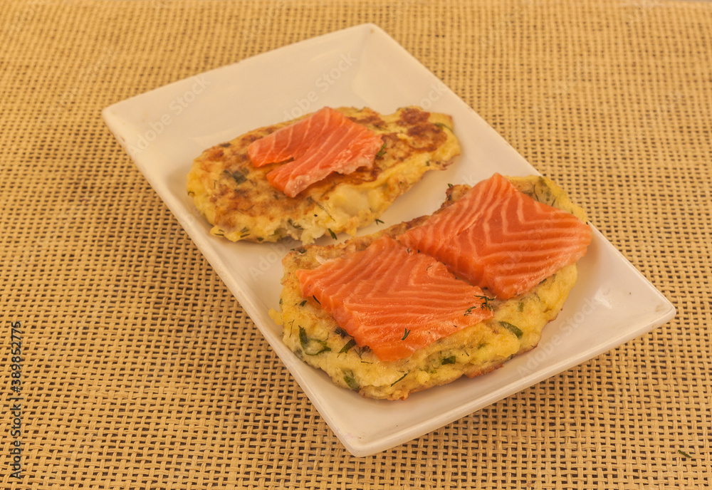 Cauliflower pancakes and trout on plate Cauliflower pancakes and trout on plate