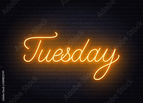 Tuesday neon sign on brick wall background .