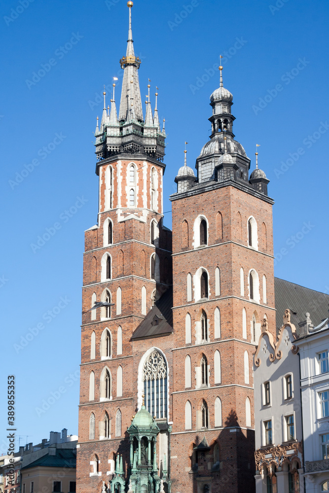 Krakow, Poland - February 17, 2019: Old city center view with Adam Mickiewicz monument and St. Mary's Basilica in Krakow