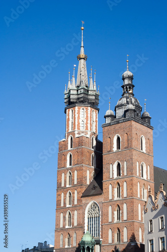 Krakow, Poland - February 17, 2019: Old city center view with Adam Mickiewicz monument and St. Mary's Basilica in Krakow