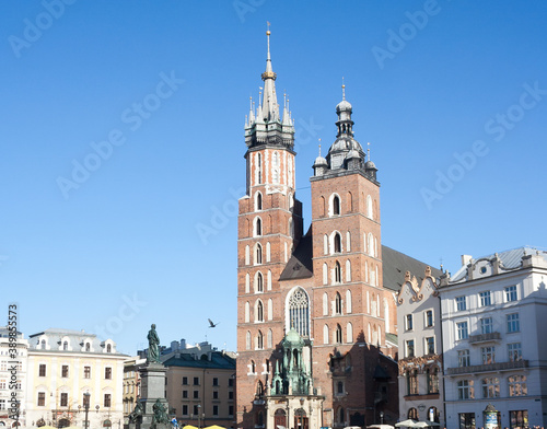 Old city center view with Adam Mickiewicz monument and St. Mary's Basilica in Krakow