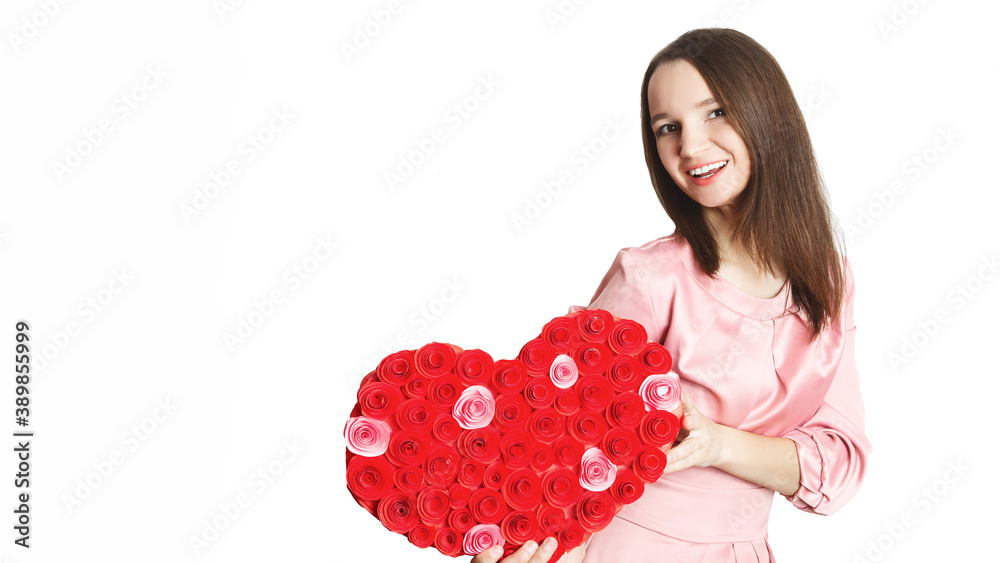 Happy Valentine's day! portrait of a beautiful smiling caucasian young woman holding huge red paper heart and looking at camera with toothy smile on white background. copy space. Romantic concept. Happy Valentine's day! portrait of a beautiful smiling caucasian young woman holding huge red paper heart and looking at camera with toothy smile on white background. copy space. Romantic concept.