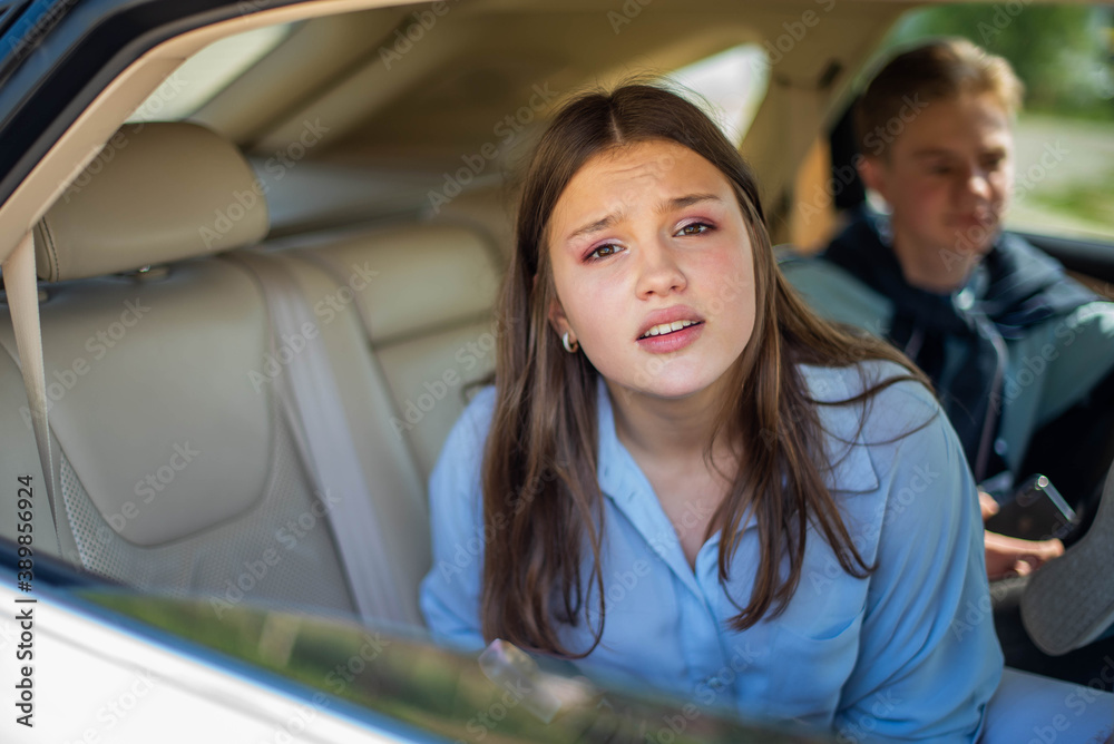 Group Of Young Cheerful People with a bottle of alcohol in car, alcoholism concept. Social problem, violation of the law. Teen alcohol addiction concept Group Of Young Cheerful People with a bottle of alcohol in car, alcoholism concept. Social problem, violation of the law. Teen alcohol addiction concept