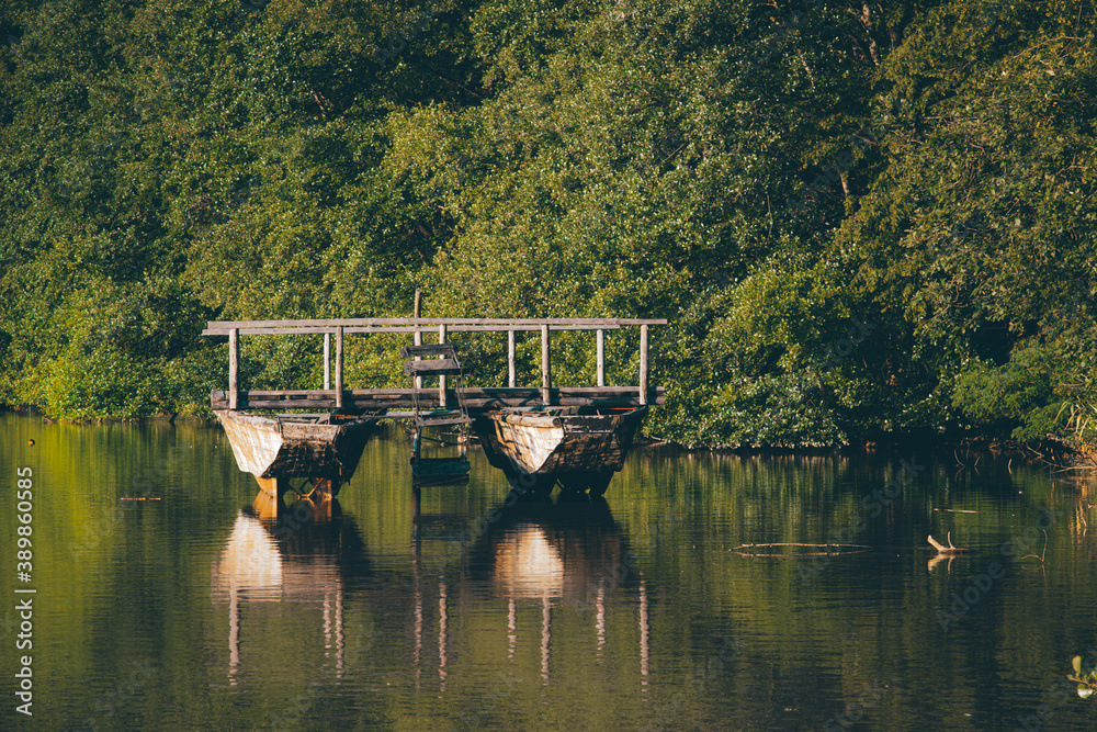 Obraz premium rural landscape with old wooden boat on a lake