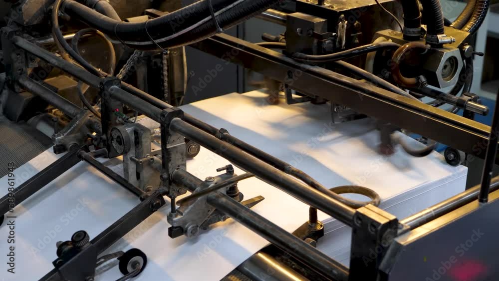 Printing machine print paper in typography. Fake news, untrue information presented as news concept Printing machine print paper in typography. Fake news, untrue information presented as news concept